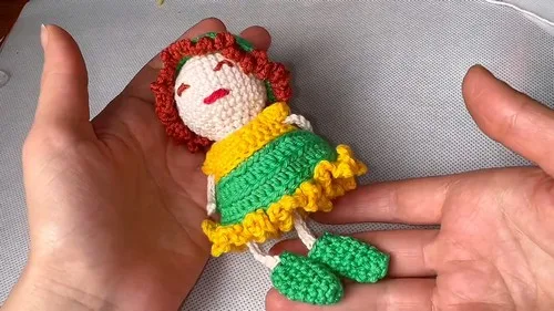 Crochet amigurumi doll with dress, shoes, and hat